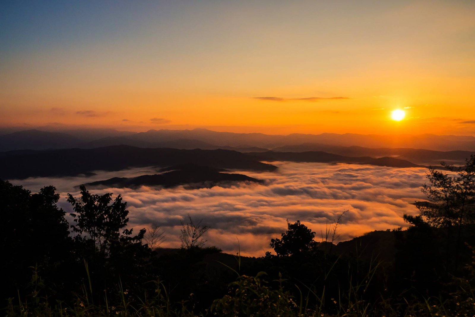 Sunset overlooking mountains with mist